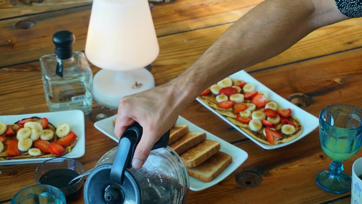 person holding stainless steel kettle